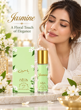 A woman in a white robe rests beside a bottle and matching box of Jasmine floral perfume. The packaging is light green with white floral illustrations and gold lettering, set on a marble surface with white flowers and soft warm lighting.