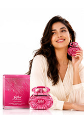 Woman holding Chris Adams Gifted Pour Femme EDP 100ML pink perfume bottle