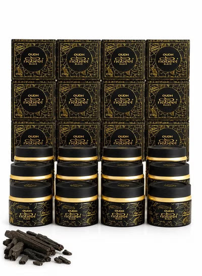 Twelve black tin jars and matching black-and-gold boxes of Oudh Sabun Sabur are arranged in a grid on a white background, with a small pile of dark powder pieces in the lower left corner.