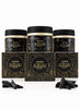 Three black cosmetic jars with gold detailing are arranged behind three matching rectangular boxes on a white background, with small pieces of black charcoal placed in front. The labels read 'OUDH nabeel BLACK'.